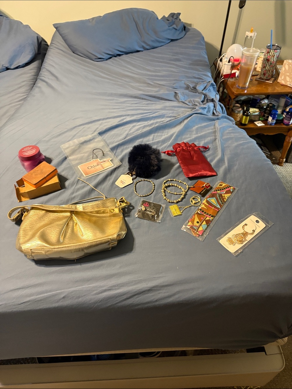Gold Leather Crossbody Bag with jewelry, soap, body scrub, purse charms